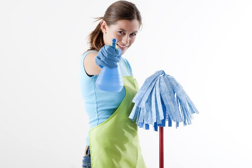 Carpet cleaning technician preparing equipment safely in a Neasden property